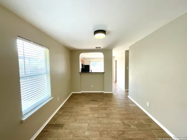 a view of a hallway with a room and a window