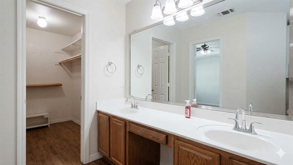 211 Vista Ridge Drive Venus, TX 76084 - Photo 15 of 24 Dual vanity with white countertop and wood-finish cabinetry