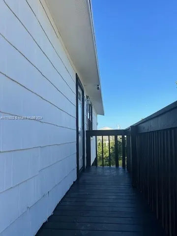 a view of a balcony with wooden floor