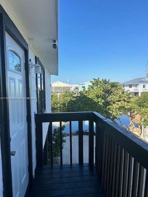 74 Pelican Lane, Unit 1 Big Pine Key, FL 33043 - Photo 13 of 23 a view of a balcony with wooden floor