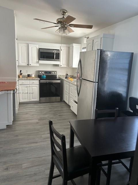 74 Pelican Lane, Unit 1 Big Pine Key, FL 33043 - Photo 16 of 23 a kitchen with cabinets stainless steel appliances and a counter space