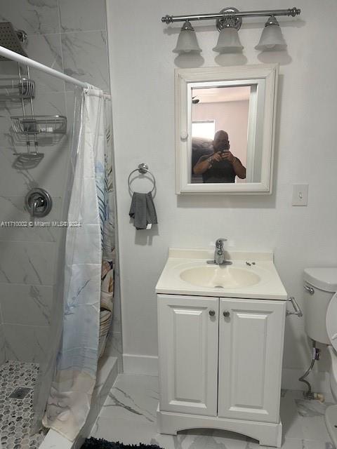 74 Pelican Lane, Unit 1 Big Pine Key, FL 33043 - Photo 21 of 23 a bathroom with a sink vanity mirror and toilet