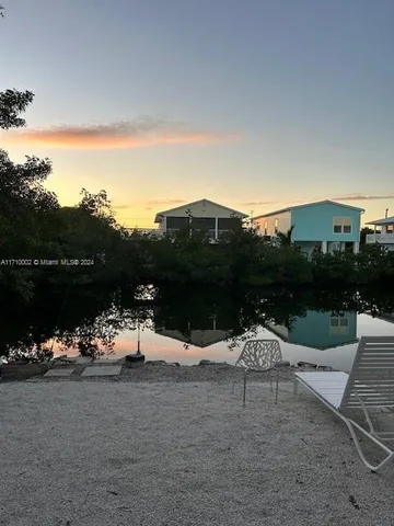 a view of a lake with couches and city view