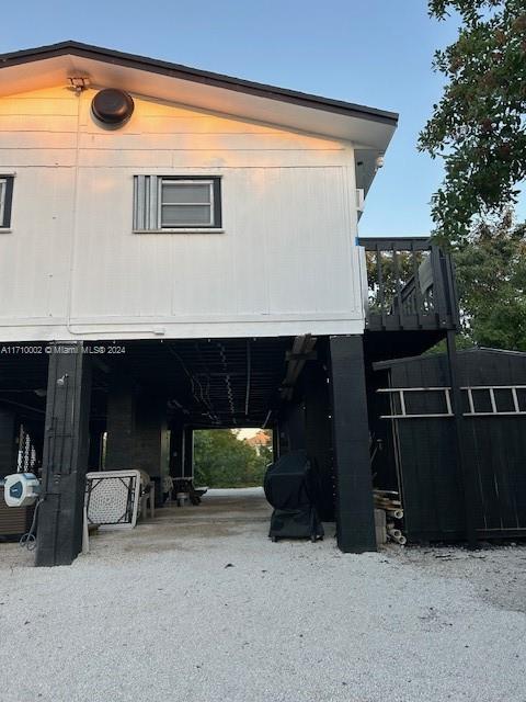 74 Pelican Lane, Unit 1 Big Pine Key, FL 33043 - Photo 7 of 23 a view of backyard with table and chairs and potted plants