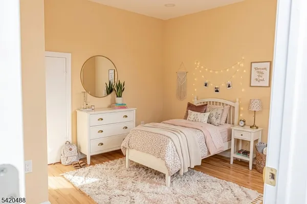 a bedroom with a bed and a painting on the wall