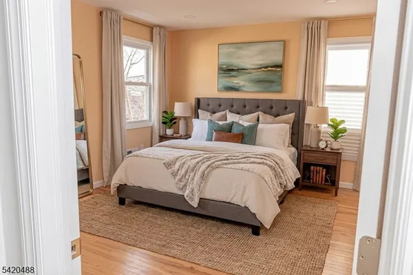 a bedroom with a bed chair and a window