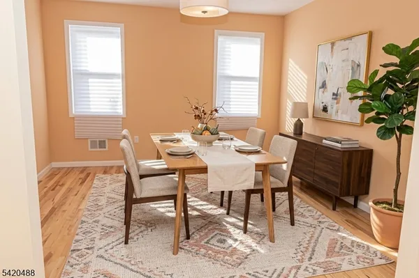 a kitchen with stainless steel appliances a stove a sink cabinets and a window