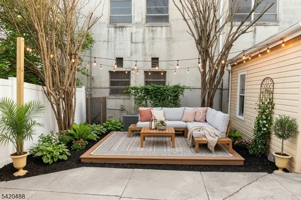 a living room with furniture and a potted plant