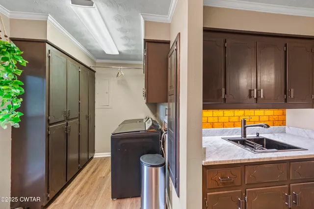 a view of a kitchen with a sink washer and dryer