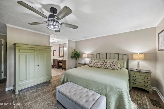 a bedroom with a bed and ceiling fan