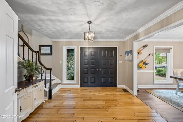a view of a hallway to a livingroom with furniture
