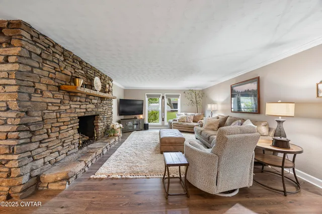 a living room with furniture a fireplace and a flat screen tv