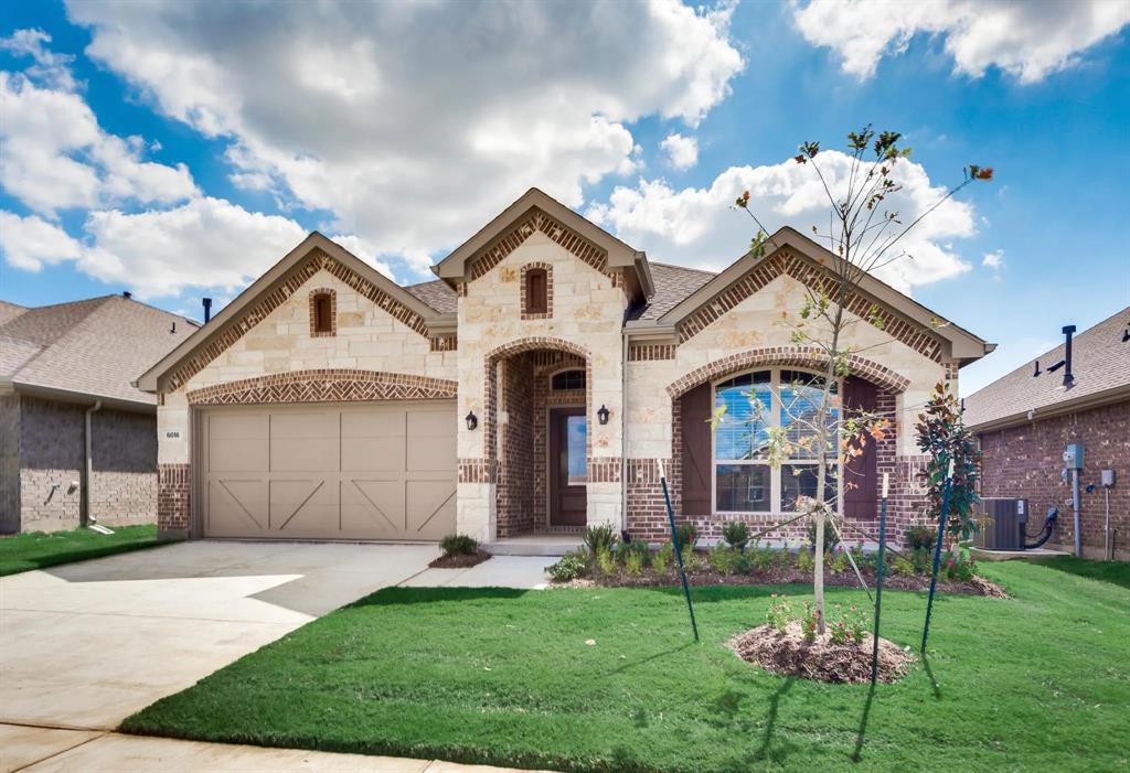 a front view of a house with a garden and plants