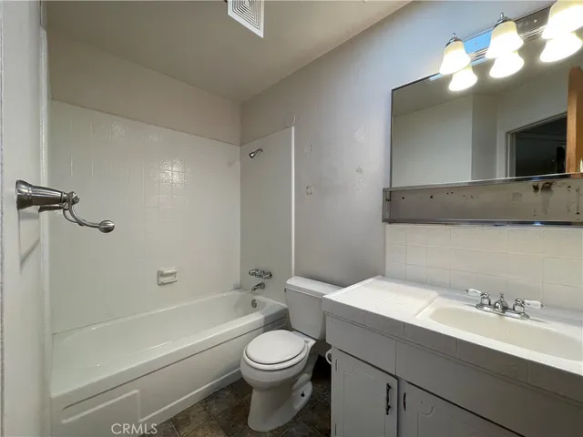 a bathroom with a sink a toilet and a bathtub