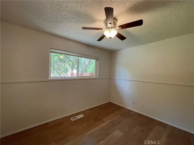 a view of a room with a window and ceiling fan