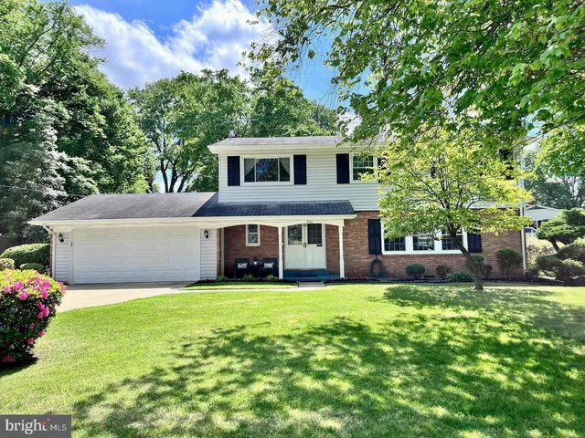 a view of a house with a yard and sitting area