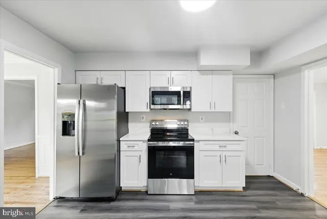 a kitchen with a sink stainless steel appliances and cabinets