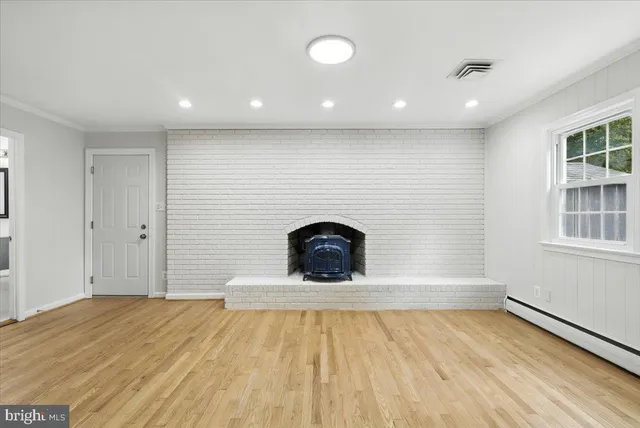 a view of empty room with windows and fireplace