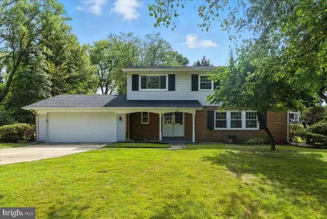 a view of a house with yard and a garden