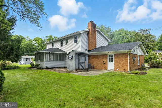 a view of a house with a yard and sitting area