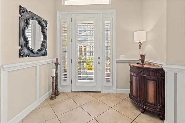 a view of a dining room and livingroom with furniture wooden floor a rug a chandelier