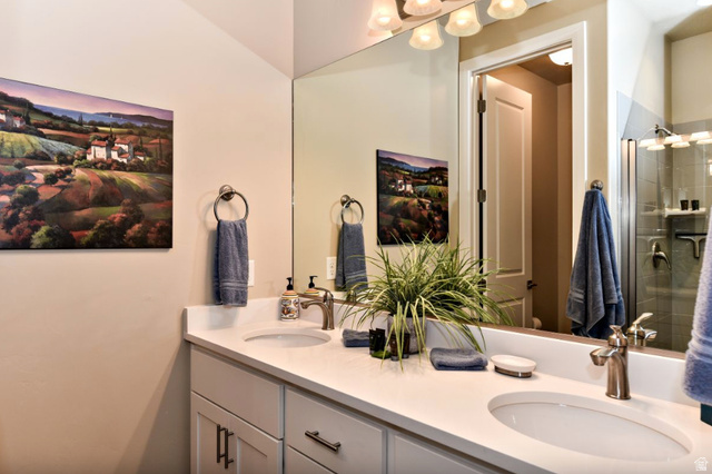 1622 Canyon Tree Drive St. George, UT 84770 - Photo 15 of 34 Bathroom featuring a double vanity with white countertops, undermount sinks, brushed nickel faucets, and coordinating cabinet hardware