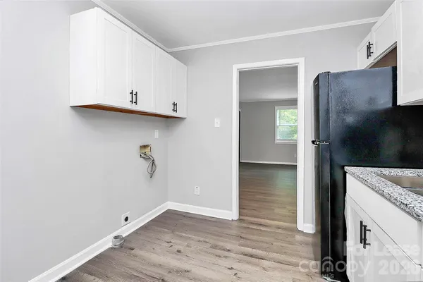 a view of kitchen with granite countertop cabinets and wooden floor