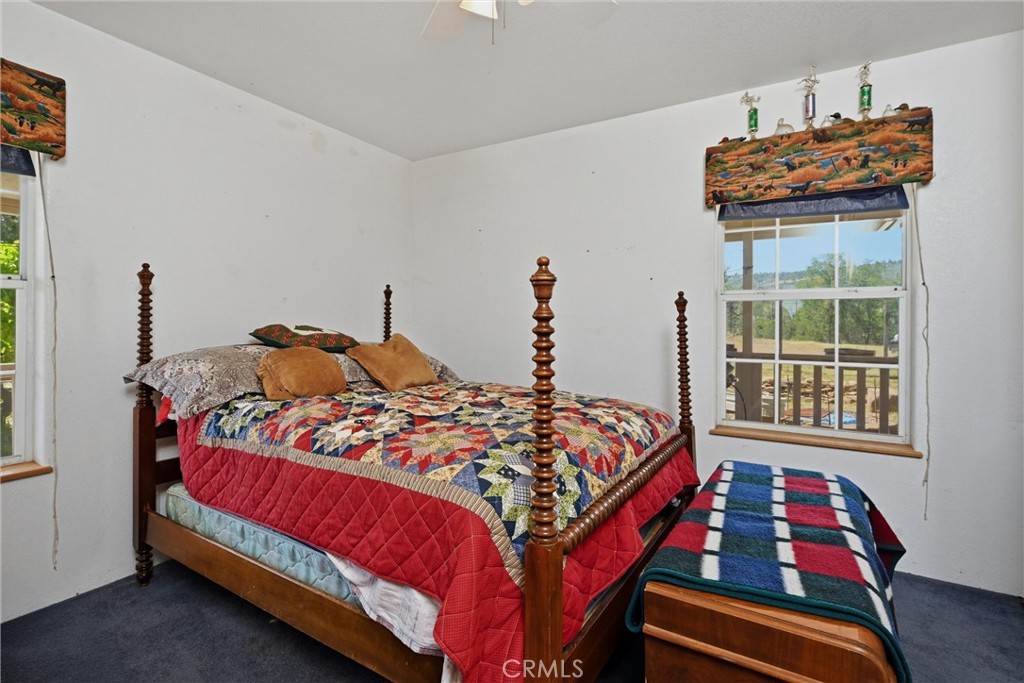 16965 Spruce Grove Road Hidden Valley Lake, CA 95467 - Photo 15 of 34 a bedroom with bed and wooden floor