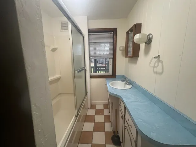 a bathroom with a sink a vanity and mirror