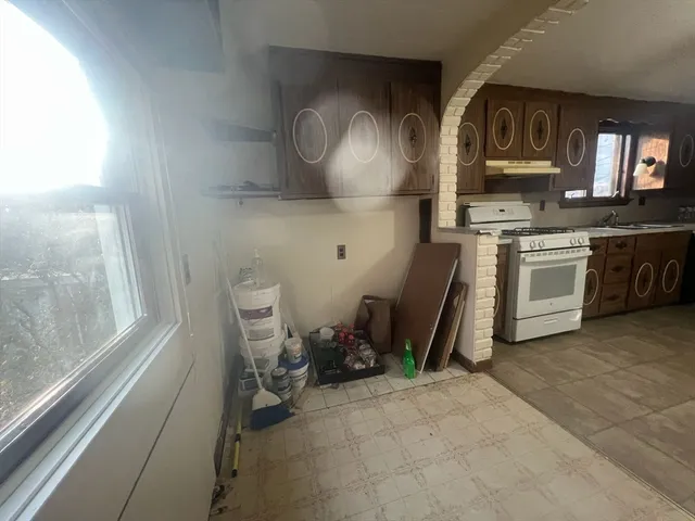 a view of entryway with furniture and wooden floor