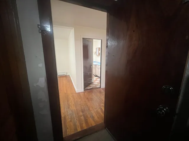 a view of a room with wooden floor and a staircase