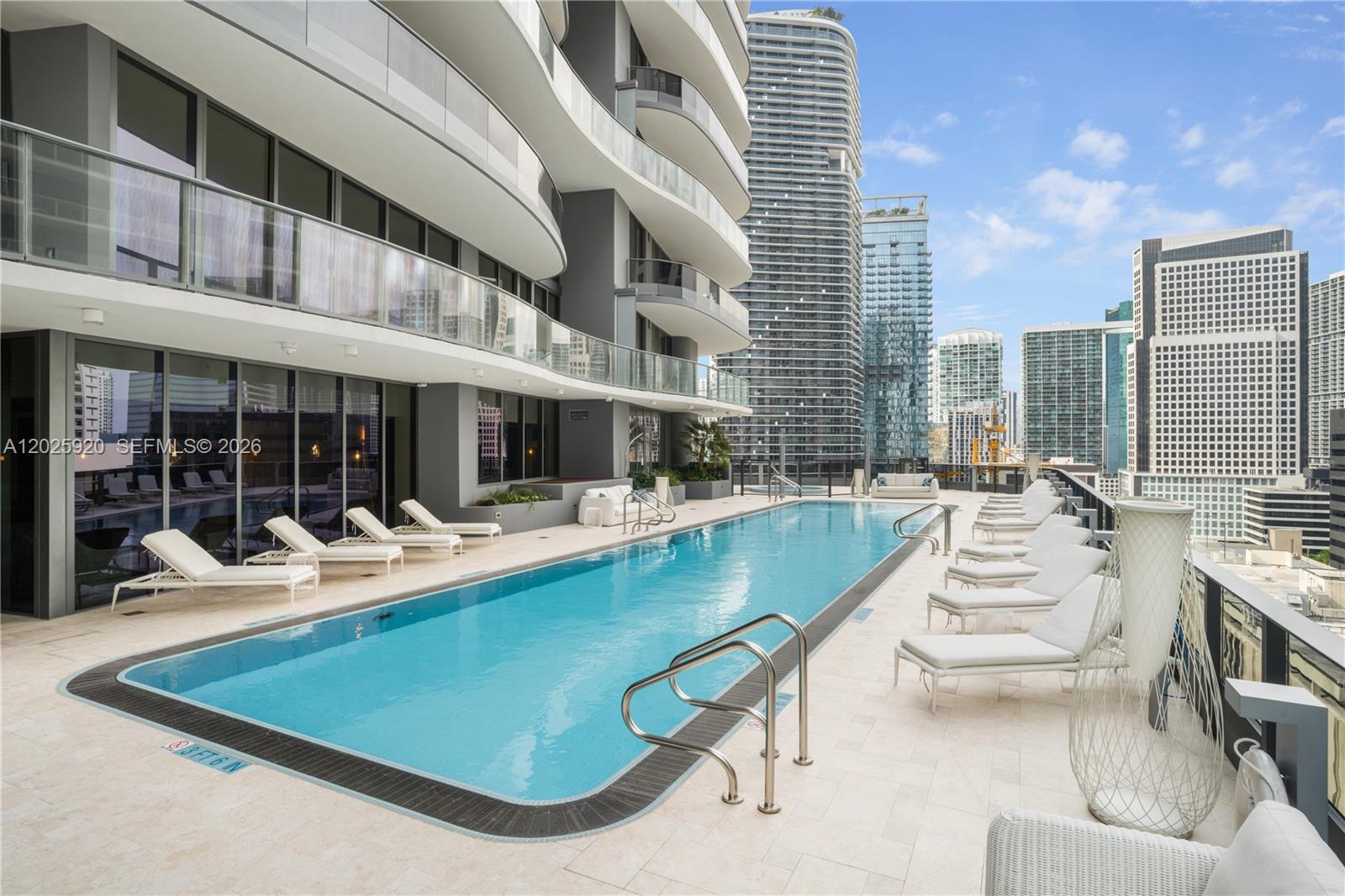 1000 Brickell, Unit 2014 Miami, FL 33131 - Photo 8 of 30 a view of a patio with couches table and chairs and potted plants