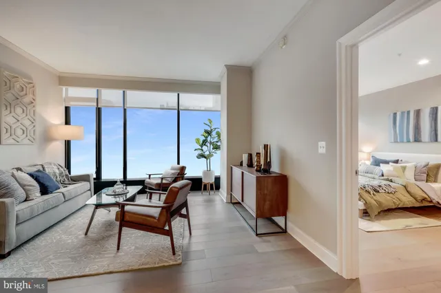 a living room with furniture and large windows