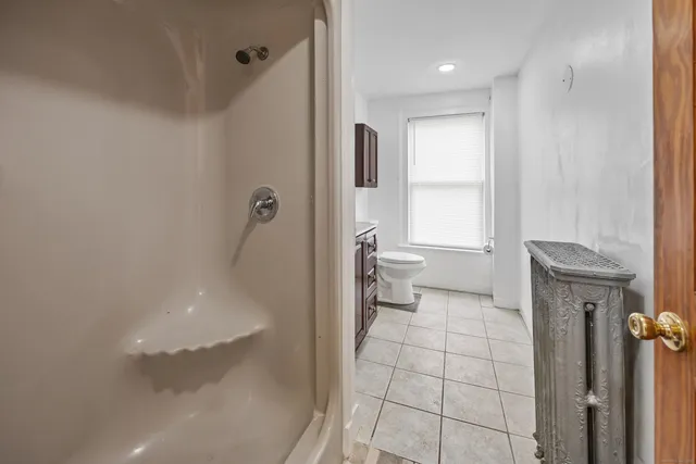 a bathroom with a toilet and a shower