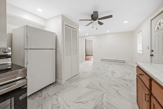 a view of a refrigerator in kitchen and wooden floor