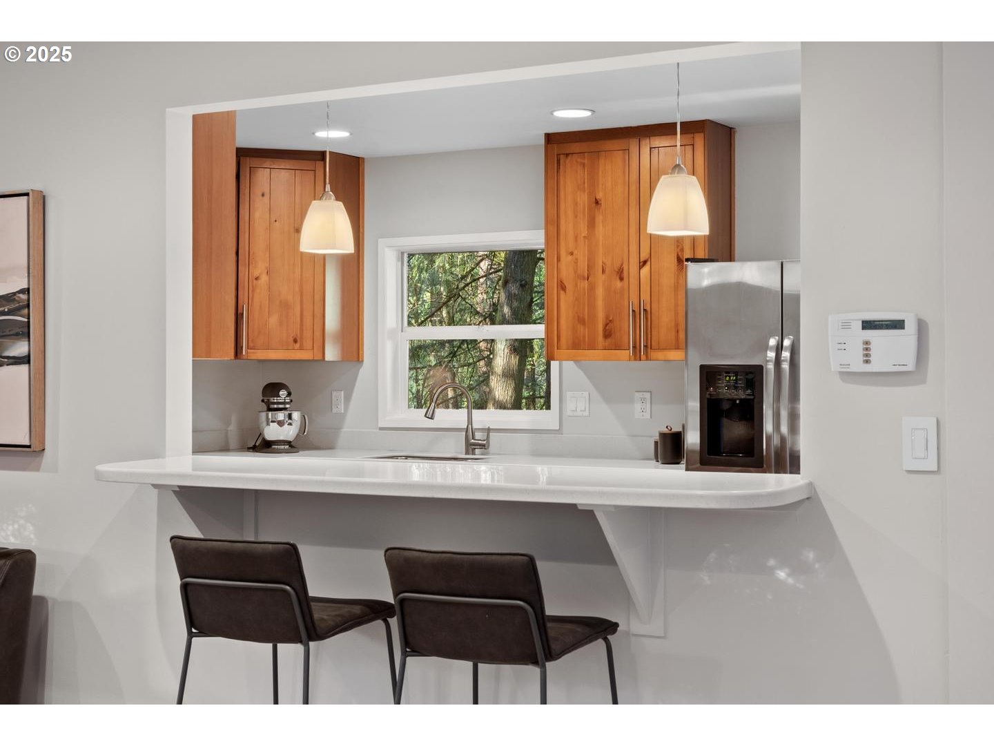 4200 West Burnside Road Portland, OR 97210 - Photo 11 of 36 a kitchen with a table chairs refrigerator a sink and dishwasher