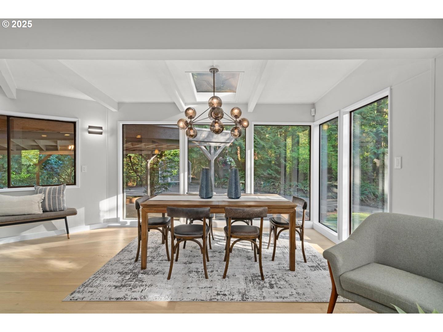 4200 West Burnside Road Portland, OR 97210 - Photo 8 of 36 a dining room with wooden floor a chandelier a glass table and chairs