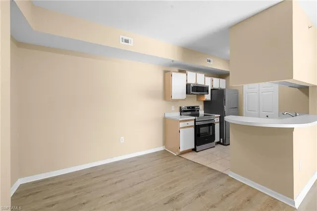 a kitchen with a sink cabinets and stainless steel appliances