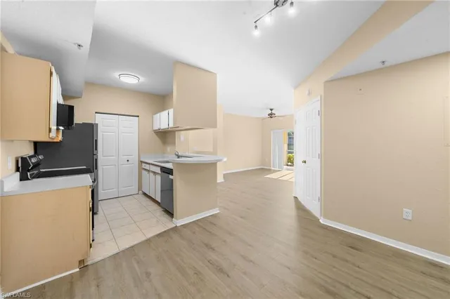 a kitchen with stainless steel appliances a refrigerator and a stove top oven