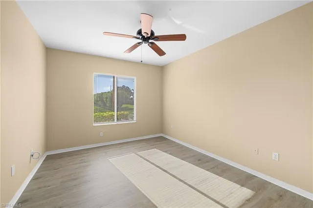 a view of room with a ceiling fan and window
