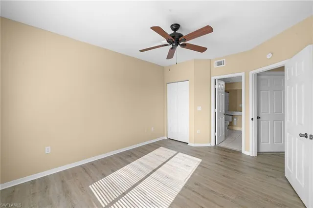 a view of a big room with wooden floor and closet area