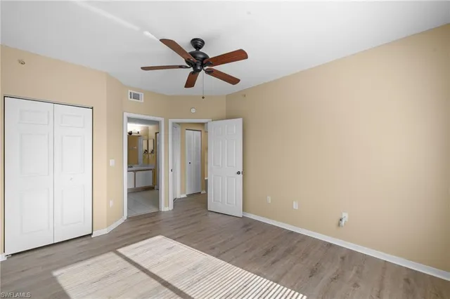a view of a big room with wooden floor and windows