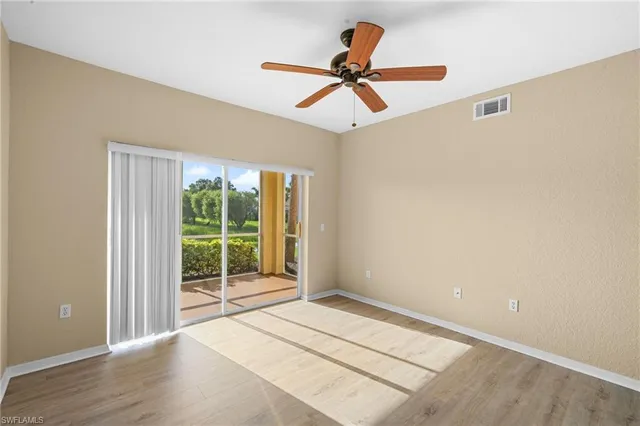 a view of a livingroom with a ceiling fan and window