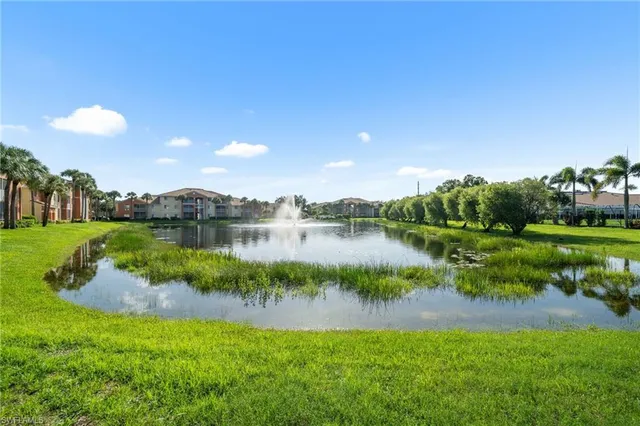 a view of a lake with houses in the back