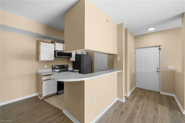 a kitchen with a refrigerator a stove top oven a sink and dishwasher