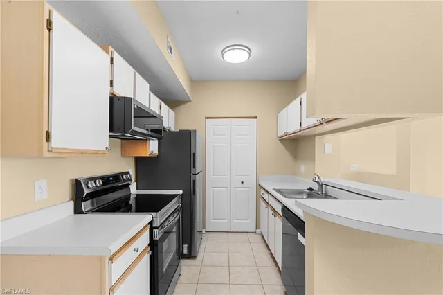 a kitchen that has a sink and a stove