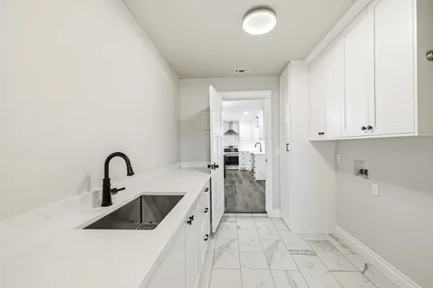 a kitchen with a sink and refrigerator