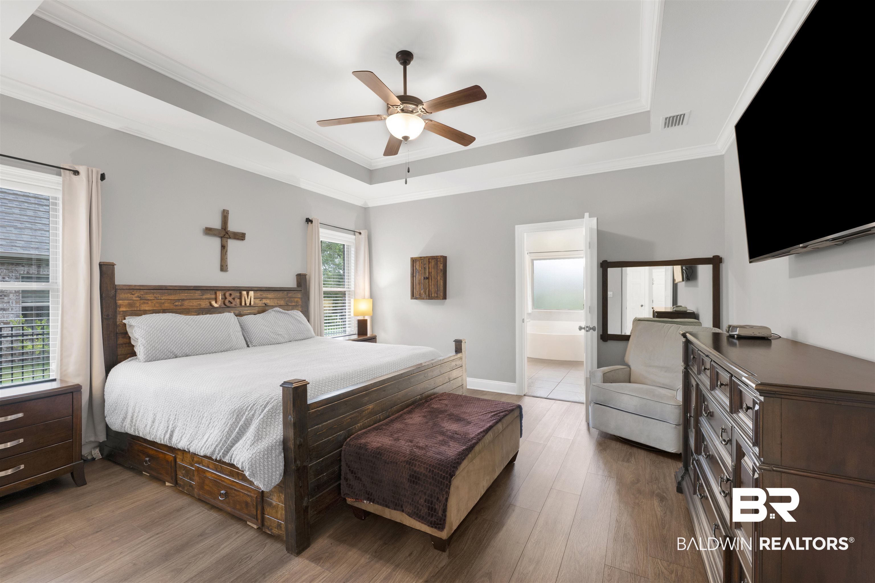 12672 Squirrel Drive Daphne, AL 36527 - Photo 21 of 49 Spacious bedroom featuring wood-finish flooring, a tray ceiling, and a ceiling fan