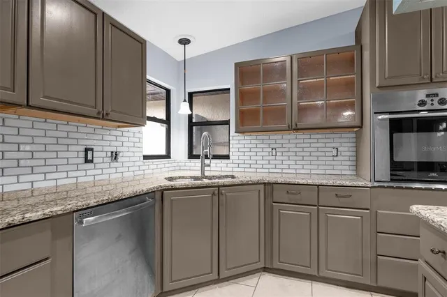 a kitchen with stainless steel appliances granite countertop a sink and stove