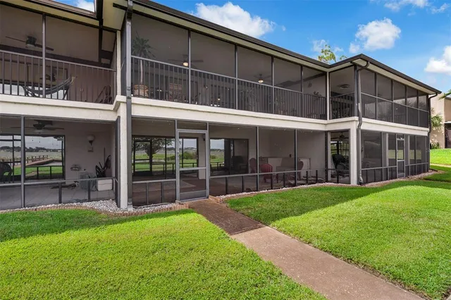 an aerial view of a residential houses with outdoor space and ocean view
